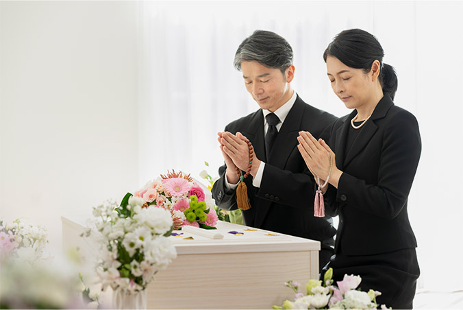 棺に手を合わせる画像